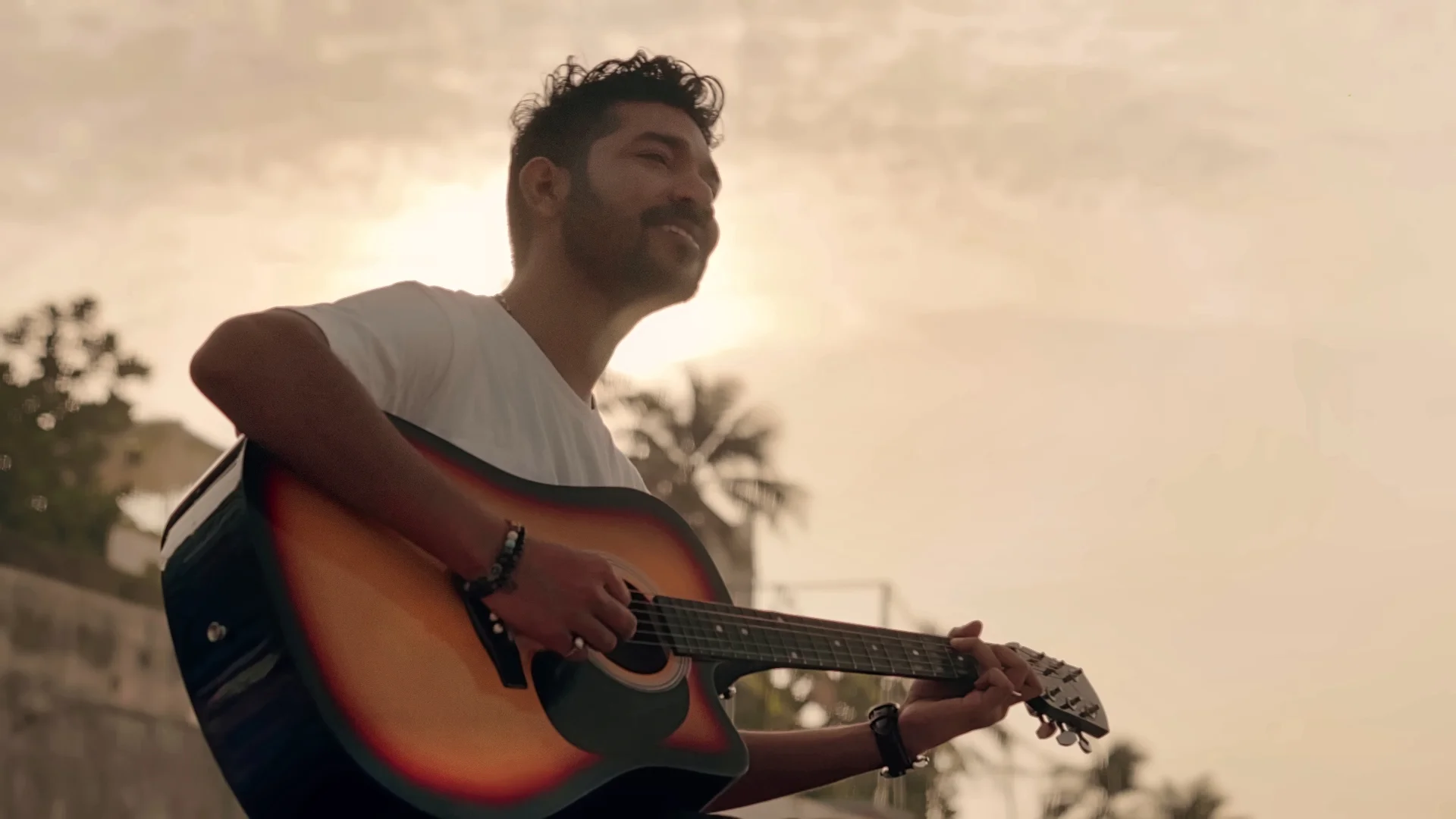 Yogi M performing live with an acoustic guitar